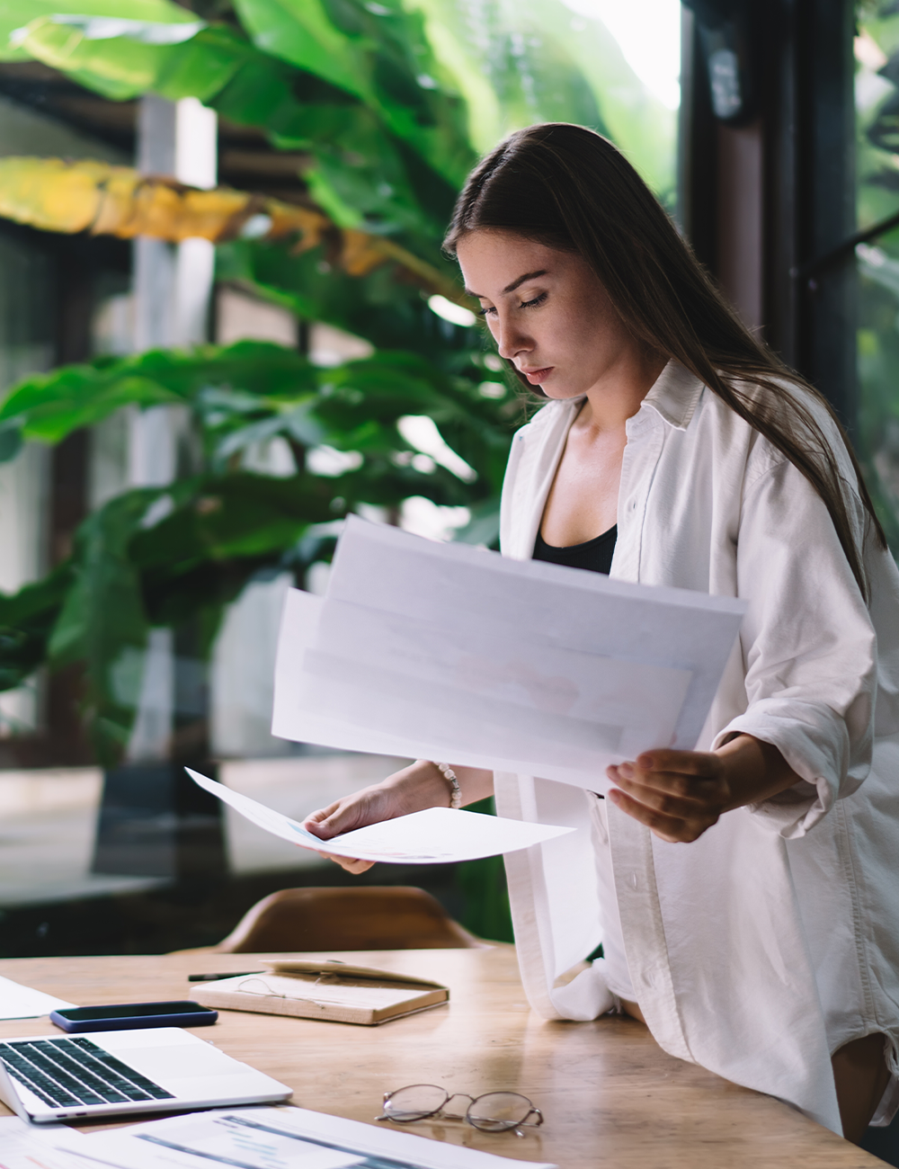 A woman looking though business papers.